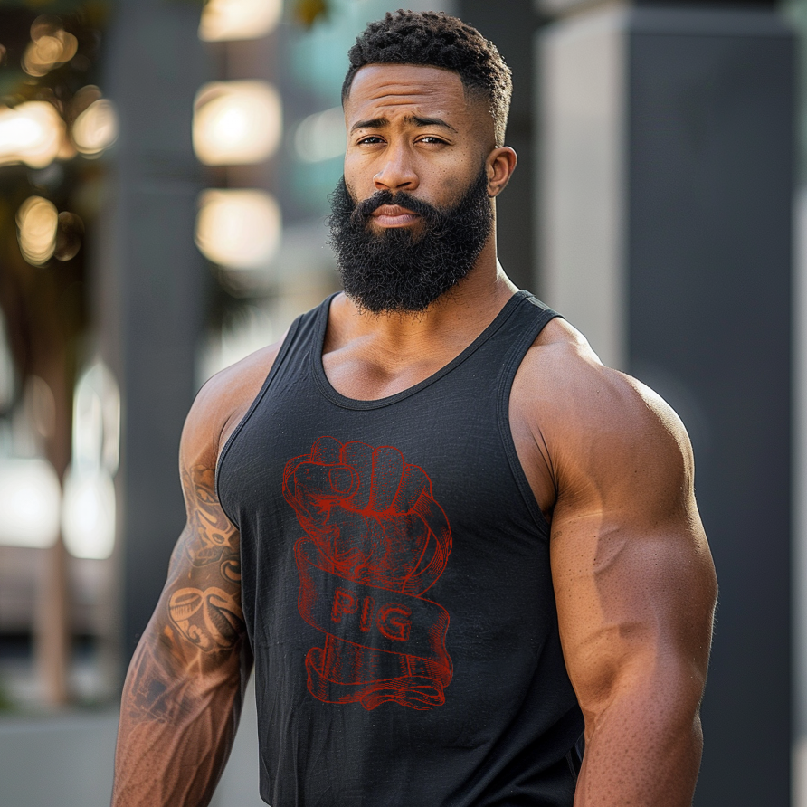Muscular man wearing a black tank top with a red graphic design outdoors.